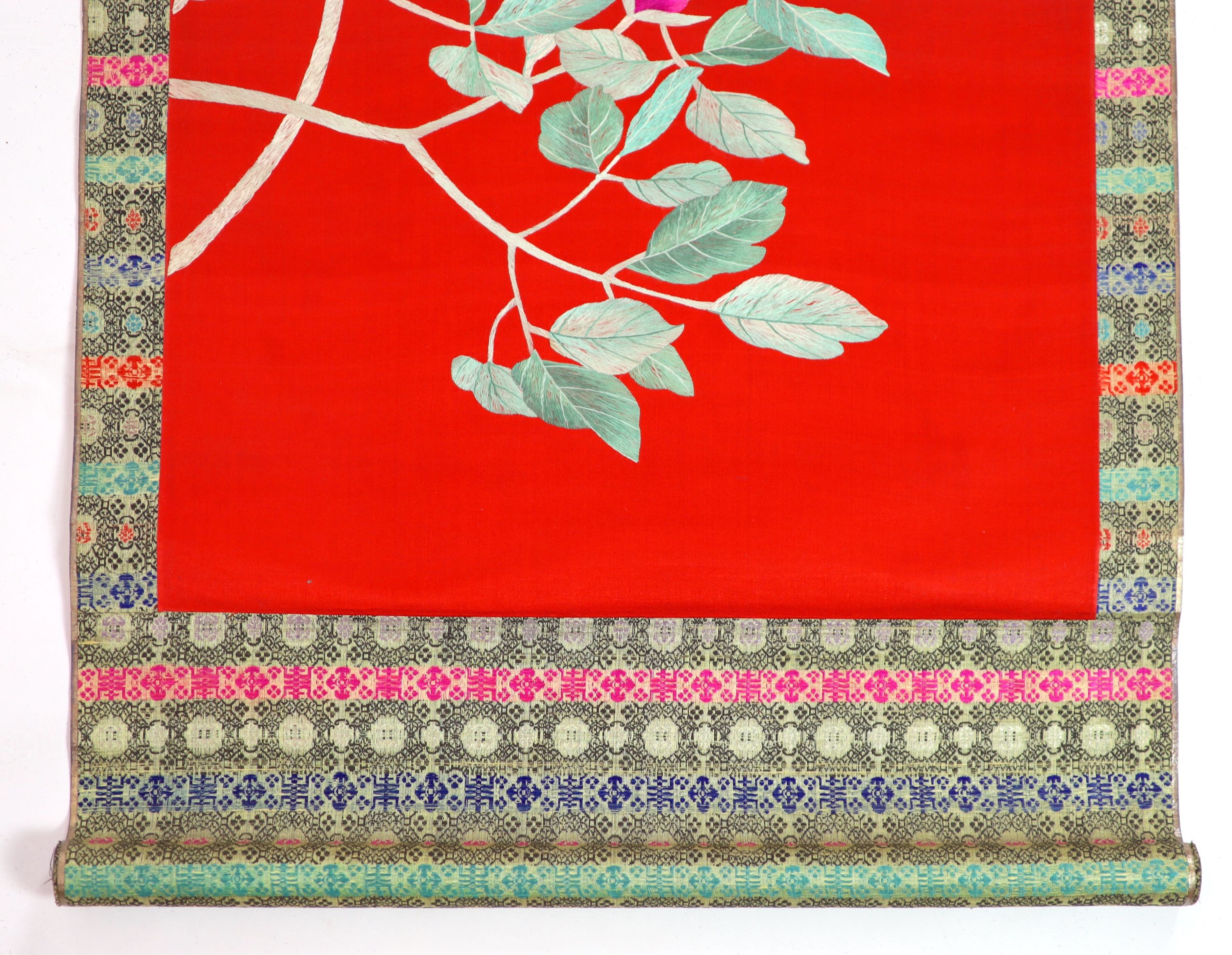 A Chinese embroidered silk ‘peacock’ scroll, late 19th century, 194 x 45 cm excluding brocade borders